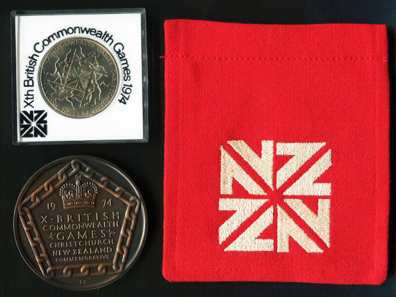 1974 COMMONWEALTH GAMES IN CHRISTCHURCH: Group with Participation Medal; blazer pocket embroidered with Games emblem; NZ $1 Coin in plastic case. Ex weightlifting official Ted Hanlon.
