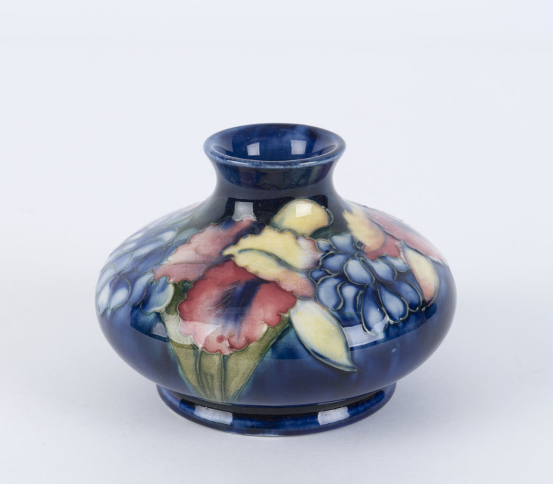 MOORCROFT "Orchid" pattern pottery vase on blue ground, late 1930s, stamped "W. Moorcroft, Potters To H.M. The Queen, Made In England", 8cm high