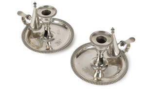 A pair of Georgian sterling silver chamber sticks with snuffers by John Bridge of London, circa 1827, 10cm high, 17cm across, 760 grams total
