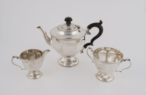 An Edwardian three piece sterling silver tea service with the maker's mark "T.A.", made in Birmingham, circa 1909, the teapot 18cm high, 620 grams total