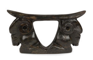 A Chinese headrest pillow, carved nephrite with ram's head decoration, ​13.5cm high, 25.5cm across