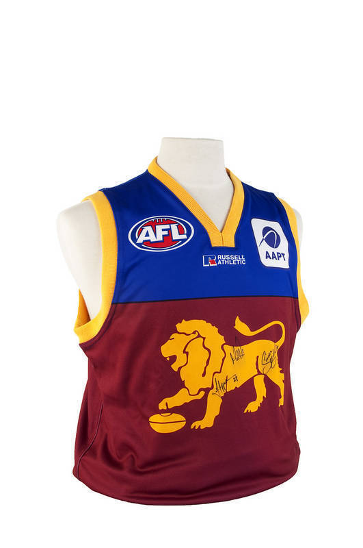 SIGNED ITEMS: Brisbane Lions jumper with 3 signatures including Michael Voss & Simon Black; 2009 Australian Masters gold shirt with 12 signatures including Ian Baker Finch & Jack Newton.