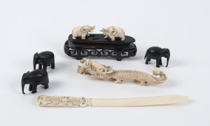 A Chinese carved ivory dragon on stand, Japanese ivory paper knife and five assorted ebony and ivory elephants, late 19th and early 20th century, ​the dragon 14cm long