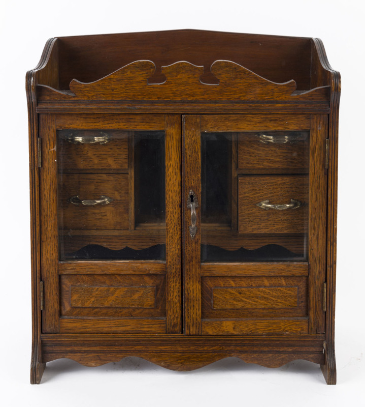 An English humidor cabinet, oak with brass and gilt metal fittings, circa 1890, 46cm high, 41cm wide, 20cm deep