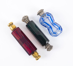 Three antique glass scent bottles with silver and gilded tops, 19th century, the largest 11.5cm long