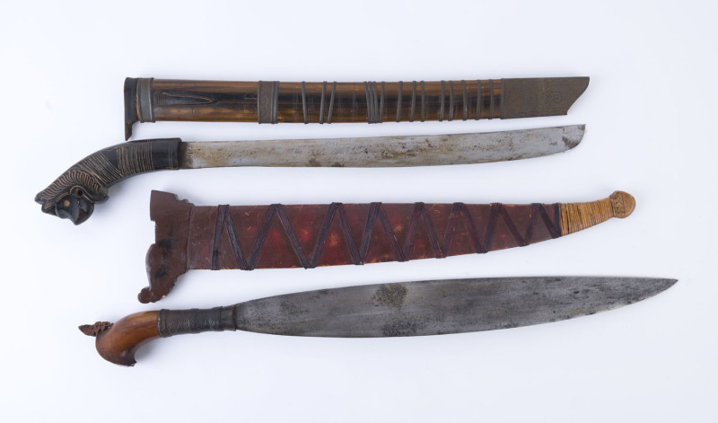 Two Talibong machetes in scabbards, Philippines, early to mid 20th century, ​57cm and 62cm long