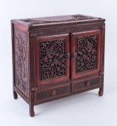 A Chinese collector's cabinet, finely carved wood with red lacquered finish, 19th century, 40cm high, 39cm wide, 21cm deep