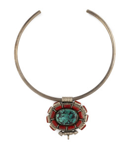 An eastern silver pendant set with large turquoise surrounded by coral segments on silver collar, the pendant 5.5cm across