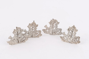 Set of four sterling silver place card holders with thistle, rose and shamrock motif, by Saunders & Shepherd, early 20th century ​4cm high, 60 grams total