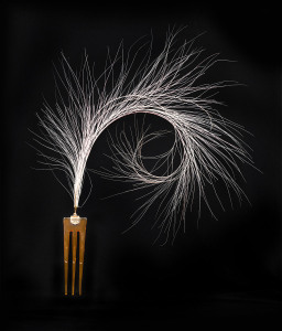 An Art Deco comb headdress, bakelite and rose gold with ostrich feather, circa 1925, 32cm high
