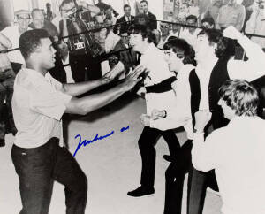 MUHAMMAD ALI & THE BEATLES, photograph of Ali clowning around with The Beatles, signed "Muhammad Ali", size 51x40cm. With CoA No.0549.