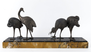 A French Art Deco statue of four cranes, spelter and marble, circa 1930, 31cm high, 65cm wide