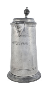 An 18th century pewter lidded jug engraved "F.D. 1776", 31cm high