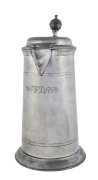 An 18th century pewter lidded jug engraved "F.D. 1776", ​31cm high