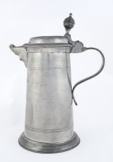 An 18th century pewter lidded jug engraved "F.D. 1776", ​31cm high - 2