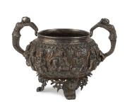 A Burmese silver bowl with deep repoussé decoration and figural handles, 19th century, 11.5cm high, 16cm across the handles, 470 grams