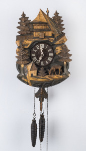 A Swiss cuckoo wall clock with carved timber mountain chalet scene case, 20th century, ​33cm high