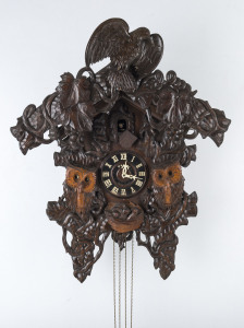 A Poppo wall clock, timber case with carved owls, Japanese, 20th century, 77cm high