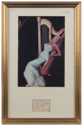 JAYNE MANSFIELD: mounted display featuring a colour photograph of platinum blonde Mansfield in evening dress leaning against a harp, signature on a plain piece beneath; framed & glazed, overall 47x30cm. - 2