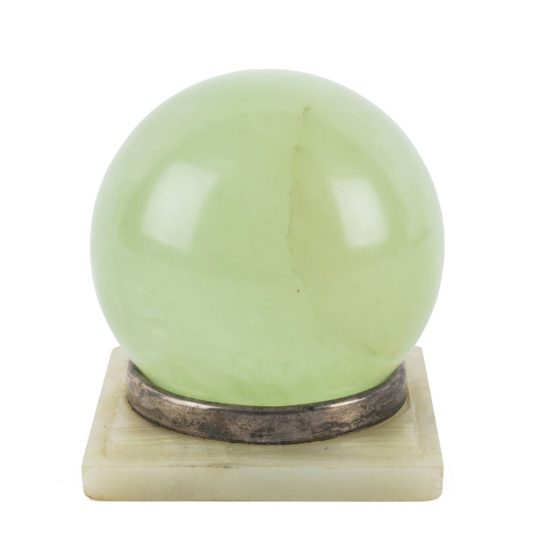 A carved green stone sphere on a sterling silver and onyx stand by Charles Boyton & Sons, circa 1913, ​11cm high