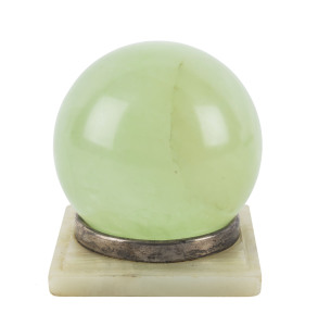 A carved green stone sphere on a sterling silver and onyx stand by Charles Boyton & Sons, circa 1913, ​11cm high