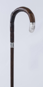 A walking stick, cane shaft with sterling silver collar and cap, also fitted with concealed pencil, 90cm high