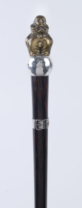 An Art Deco walking stick, rosewood shaft with sterling silver belt collar and bronze Pierrot handle, 86cm high