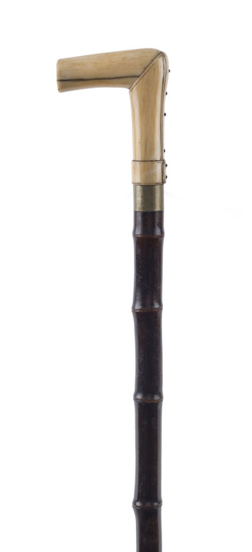 An antique walking stick, stained bamboo shaft, nickel collar and carved whalebone handle, plus concealed fold measuring stick (5 foot), ​19th century, 95cm high