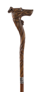 An English novelty walking stick with carved box wood dog head handle with articulated mouth and glass eyes. These sticks where popular in the early Victorian era and the mouth was used to hold gloves, mid 19th century, 94cm high