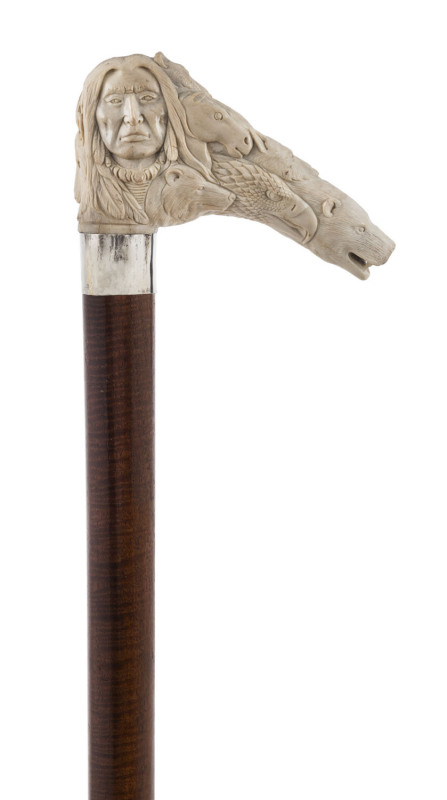 A walking stick with fiddleback timber shaft, silver collar and carved antler American Indian handle, early 20th century, 86cm high