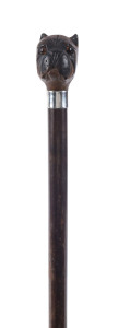 An antique walking stick, stained beech shaft with silver collar and carved timber dogs head handle with inset glass eyes, 19th century, 83cm high