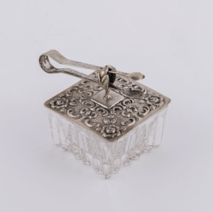 A German silver topped crystal pill box with accompanying tongs, 19th century, stamped "835", the tongs 5.5cm long