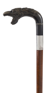 An antique English walking stick with fiddleback timber shaft, sterling silver collar and carved horn dragons head handle with bone eyes, 19th century, 91cm high