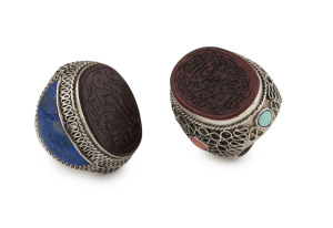 Two Persian Islamic prayer rings, filigree silver, coral, turquoise and lapis with cornelian seal tops intaglio cut with prayers, mid 20th century,