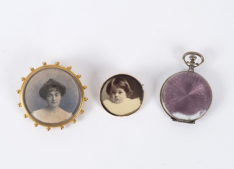 A late Victorian portrait brooch, a silver and enamel portrait locket, and a gold plated brooch with photo portrait of a young child, circa 1900-1910, (3 items), ​the largest 4cm high