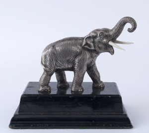 A Japanese silver elephant statue with carved bone tusks on timber base, early 20th century, 18cm high