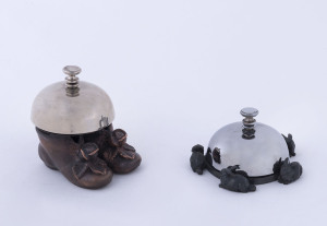 Two novelty shop counter bells, late 19th early 20th century, ​the larger 8.5cm high
