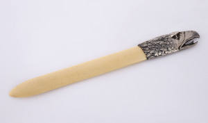 A letter opener, bone with sterling silver eagles head handle, late 19th century, stamped "925", 19cm long