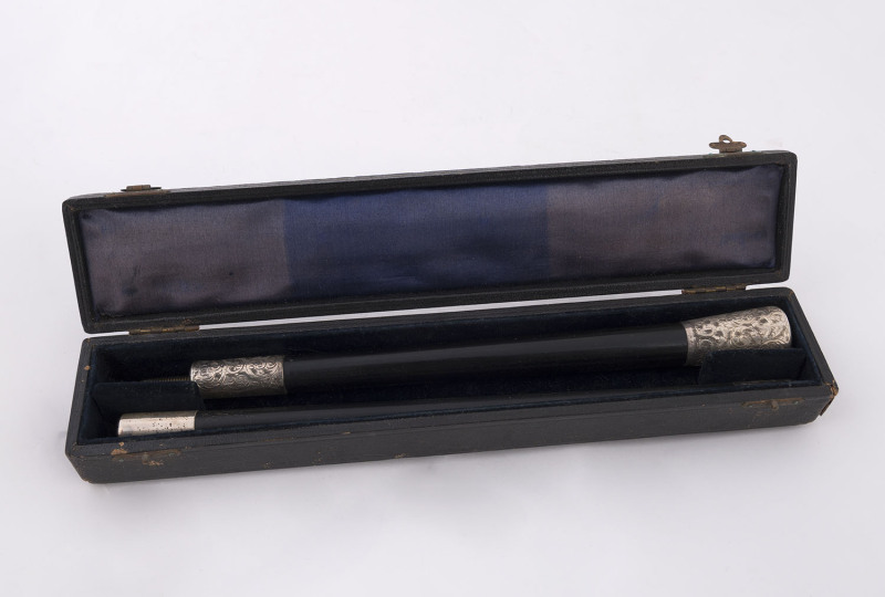 A conductor's baton, ebony shaft with engraved sterling silver mounts "Presented To Mr J.E. Jones By The Dearnley Choir" in original box, made in London, circa 1905, ​44cm long