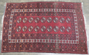 An Oriental hand-woven rug on red background, 20th century, ​195 x 123cm