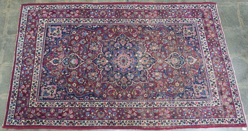 A hand-woven Persian rug on red background, circa 1930s, ​211 x 132cm