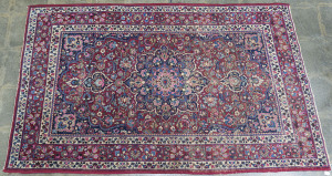 A hand-woven Persian rug on red background, circa 1930s, ​211 x 132cm