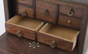 An Anglo-Indian spice box, padouk and sandalwood sumptuously inlaid with brass, bone, silver and ebony, interior fitted with seven staggered drawers, with original key, late 18th early 19th century, 13cm high, 19cm wide, 13cm deep - 5