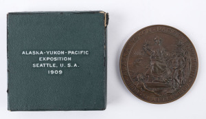 Collectables: Exhibitions: 1909 Alaska Yukon Pacific Exposition: Award Medal in bronze, 76 mm, 180gms. Inscribed SILVER MEDAL. The obverse shows a seated female figure with olive branch in one hand and a plaque of George Washington in the other. She is flanked by two prospectors or pioneers, as well as an Indian in a canoe. Made by the Gorham Company; in original box of issue.