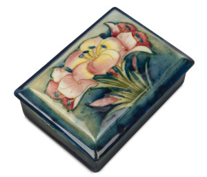 MOORCROFT "Crocus" pattern jewellery box on green/blue ground, circa 1930, incised signature and stamped "W. Moorcroft, Potter To H.M. The Queen", with paper label, 4cm high, 12cm wide, 9cm deep