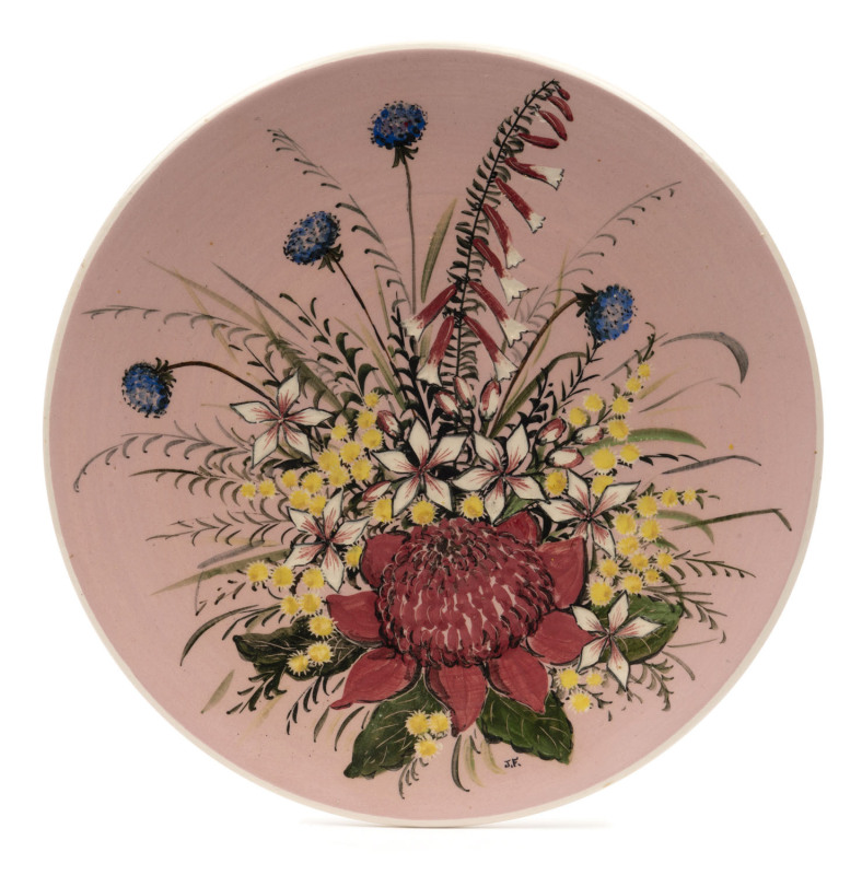 GUY BOYD pottery plaque with Australian wildflowers on pink ground, incised "Guy Boyd, Australia", ​23cm diameter