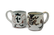 JOHN PERCEVAL: Two pottery teacups, incised "Perceval", ​8cm high, 11cm wide