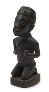 An African carved wooden offering statue, 19th/20th century, ​20cm high