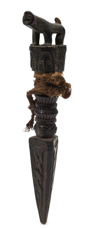 A Tibetan phurba, carved wood with animal finial and remains of silk binding, 19th century, 18cm long