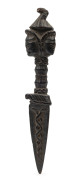 A Tibetan phurba, carved wood with three faces surmounted by a bird's head finial, 18th/19th century, 21.5cm long